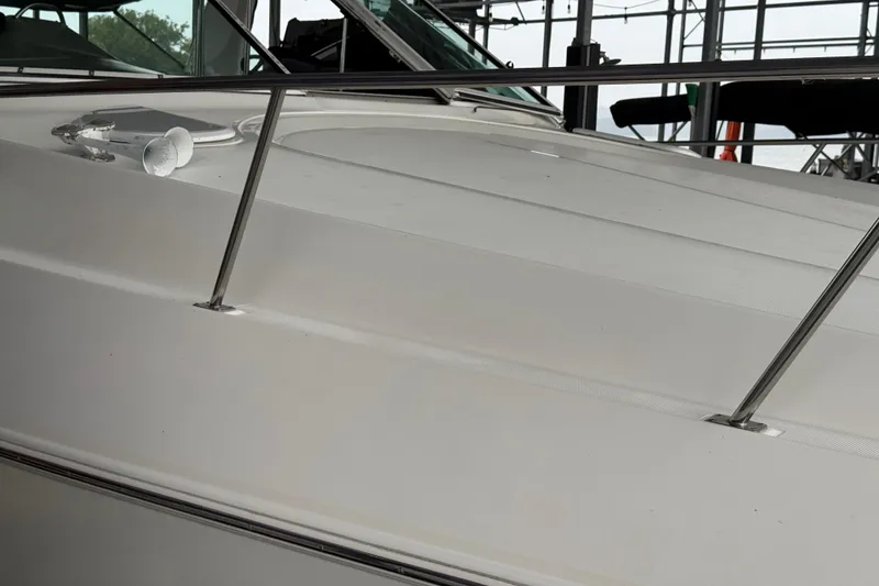 Slide: The Image of 2001 Cruisers Yachts 3672 Express boat deck with railing in marina setting. - 18