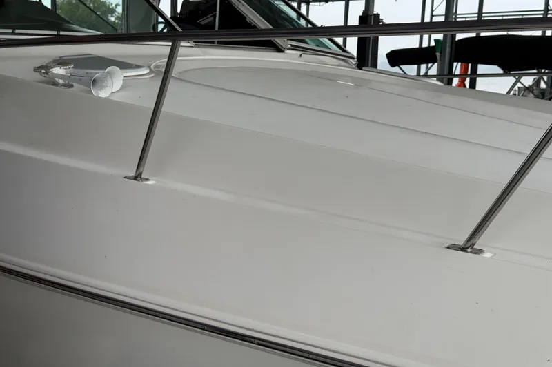Slide: The Image of 2001 Cruisers Yachts 3672 Express deck with railing and hatch detail. - 19