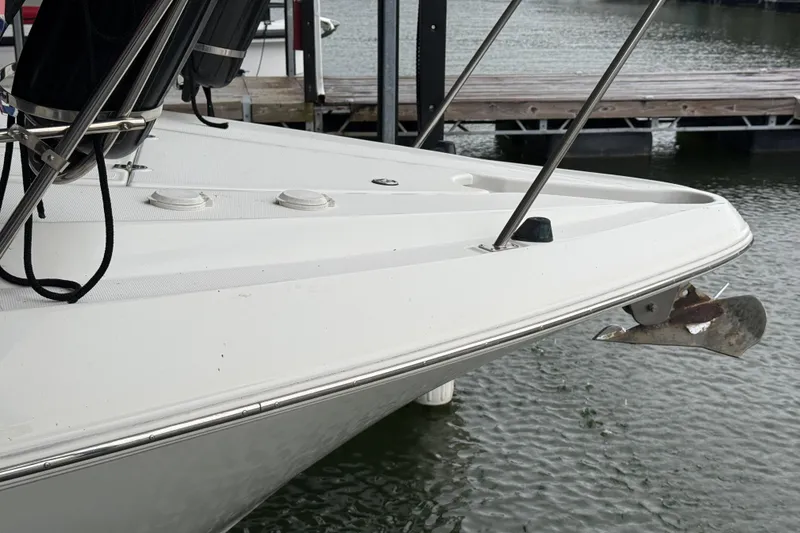 Slide: The Image of 2001 Cruisers Yachts 3672 Express bow with anchor, docked on calm water. - 22