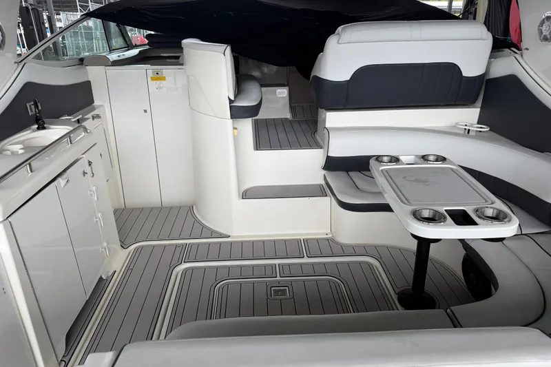 Slide: The Image of 2001 Cruisers Yachts 3672 Express interior with seating, table, and kitchenette. - 32