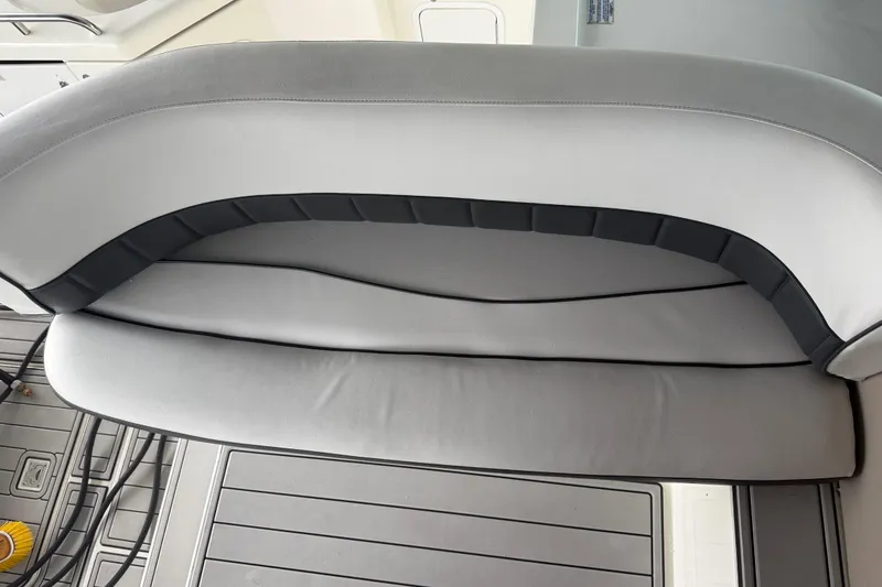 Slide: The Image of 2001 Cruisers Yachts 3672 Express interior seating, featuring sleek gray upholstery. - 33