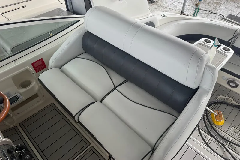 Slide: The Image of 2001 Cruisers Yachts 3672 Express interior with white and black seating, cup holders, and steering wheel. - 34