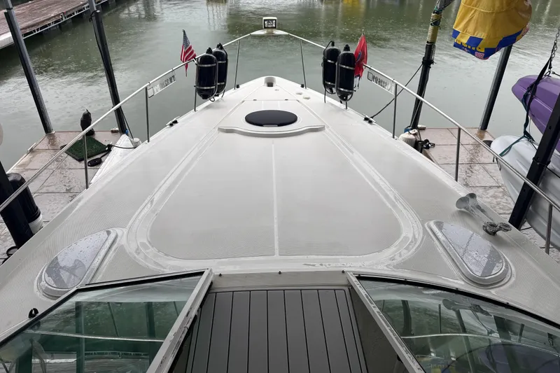 Slide: The Image of 2001 Cruisers Yachts 3672 Express docked, showcasing sleek deck design and marina setting. - 35