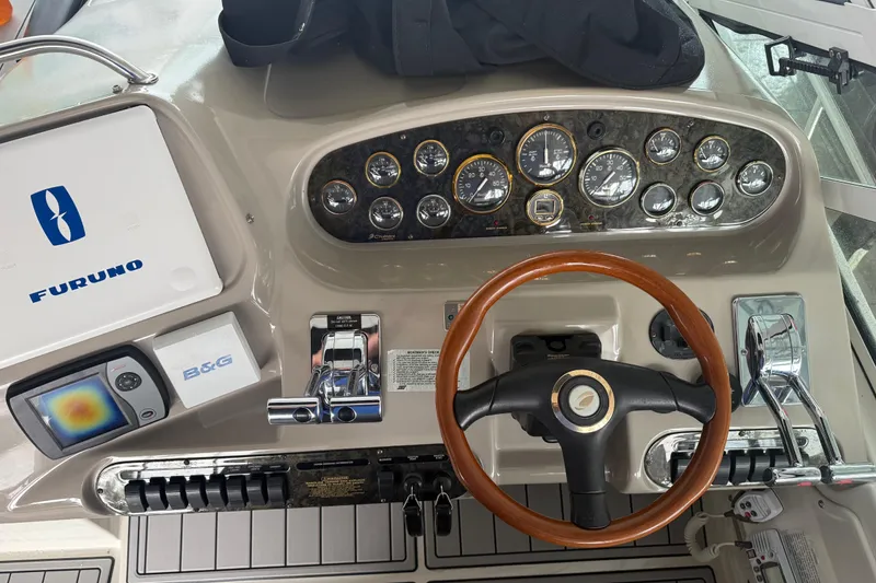 Slide: The Image of 2001 Cruisers Yachts 3672 Express helm with gauges, steering wheel, and navigation equipment. - 41