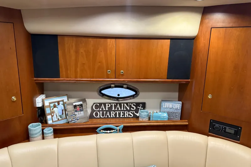 Slide: The Image of Interior of 2001 Cruisers Yachts 3672 Express with decorative items and wooden cabinetry. - 48
