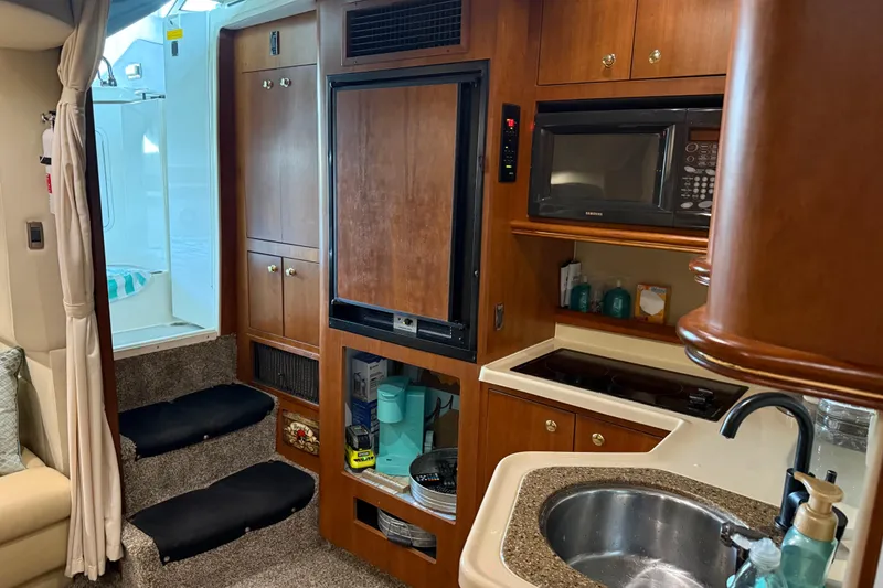 Slide: The Image of 2001 Cruisers Yachts 3672 Express interior with kitchenette, microwave, and sink. - 49