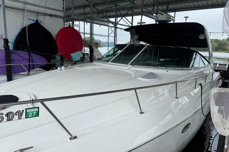 Slide: The Image of 2001 Cruisers Yachts 3672 Express docked in a covered marina. - 6