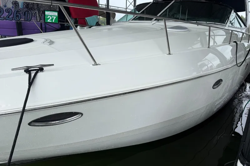 Slide: The Image of 2001 Cruisers Yachts 3672 Express, sleek white exterior, docked in marina. - 7