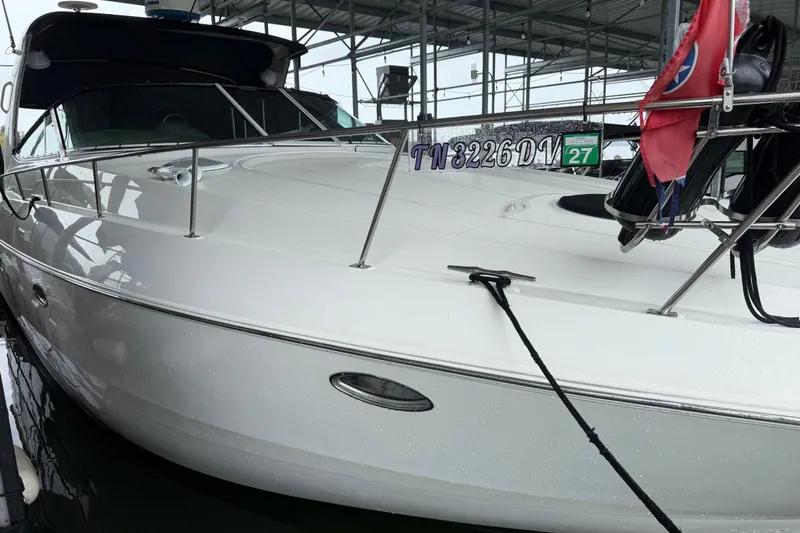 Slide: The Image of 2001 Cruisers Yachts 3672 Express docked, showcasing sleek white exterior and registration details. - 8