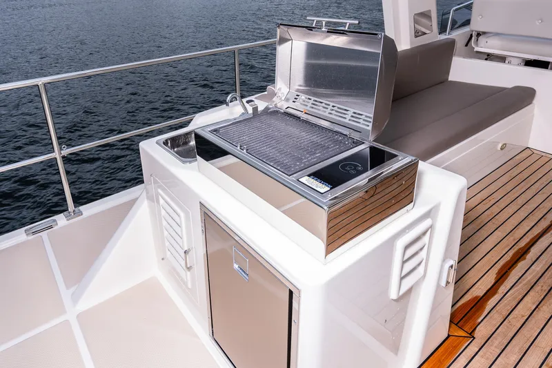 Slide: The Image of Outdoor grill on 2024 Fleming 58 Pilothouse yacht deck, overlooking water. - 11