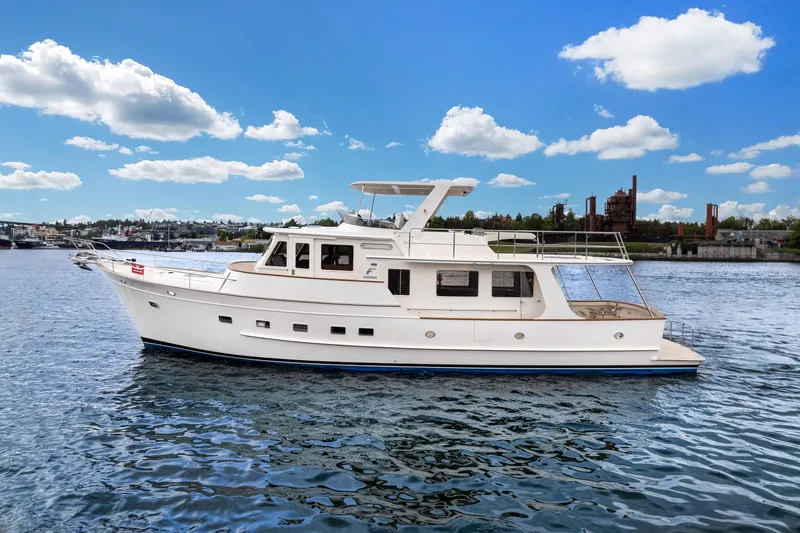 Slide: The Image of 2024 Fleming 58 Pilothouse yacht on calm water under a blue sky. - 2