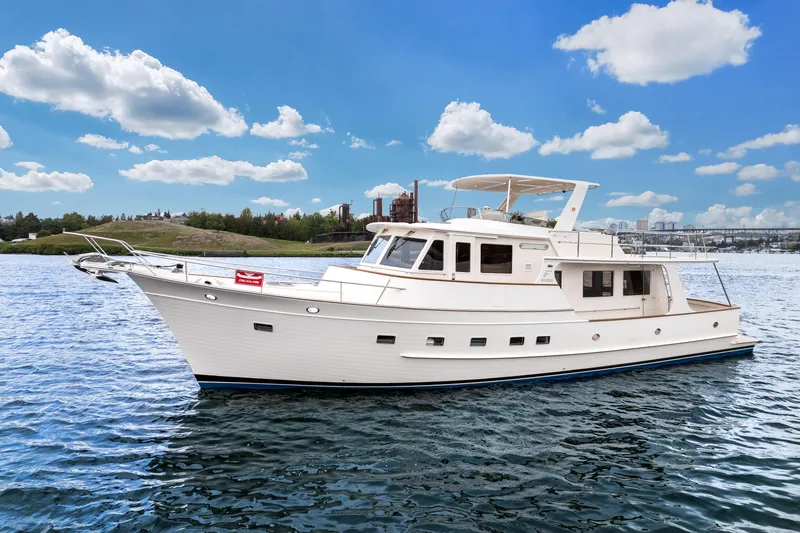 Slide: The Image of 2024 Fleming 58 Pilothouse yacht cruising on a sunny day with blue skies. - 3