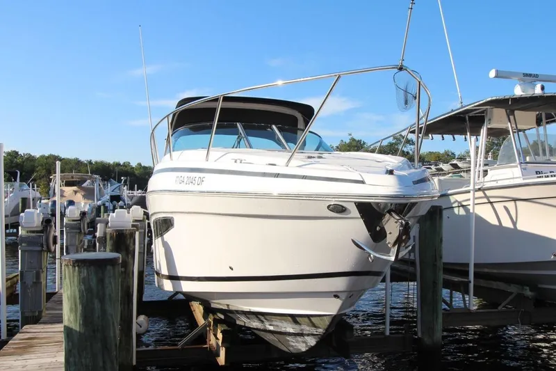 Slide: The Image of 2015 Regal 32 Express boat docked at marina under clear blue sky. - 1