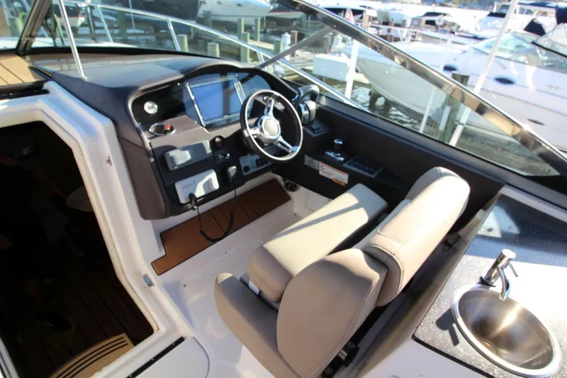 Slide: The Image of Cockpit of 2015 Regal 32 Express boat with steering wheel and control panel. - 13