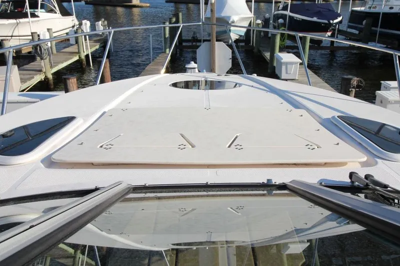 Slide: The Image of 2015 Regal 32 Express boat deck view at marina with docked boats. - 14
