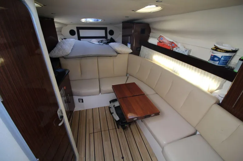 Slide: The Image of Luxurious interior of 2015 Regal 32 Express yacht with beige seating and wooden accents. - 16