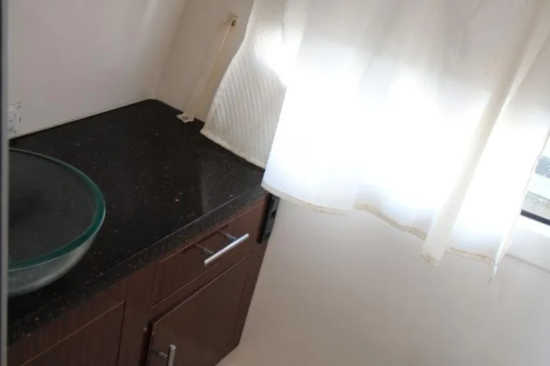 Slide: The Image of 2015 Regal 32 Express bathroom with glass sink and dark countertop. - 20