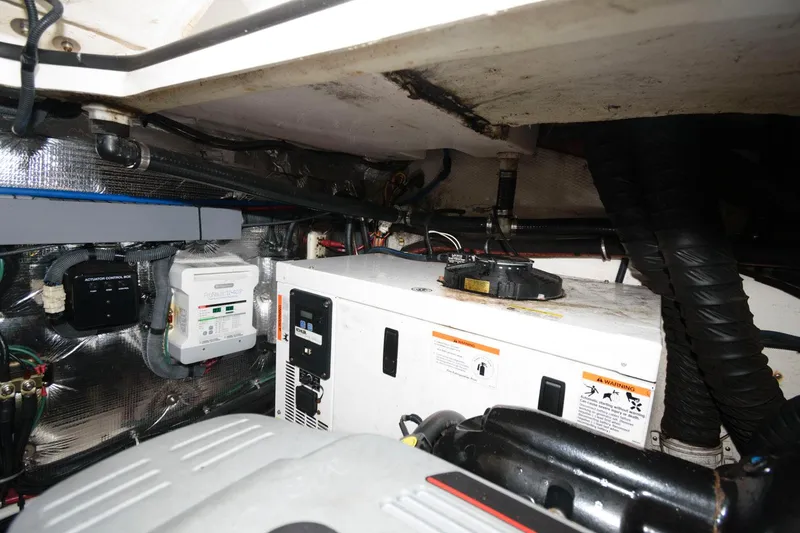 Slide: The Image of Engine compartment of a 2015 Regal 32 Express boat showing various mechanical components. - 23