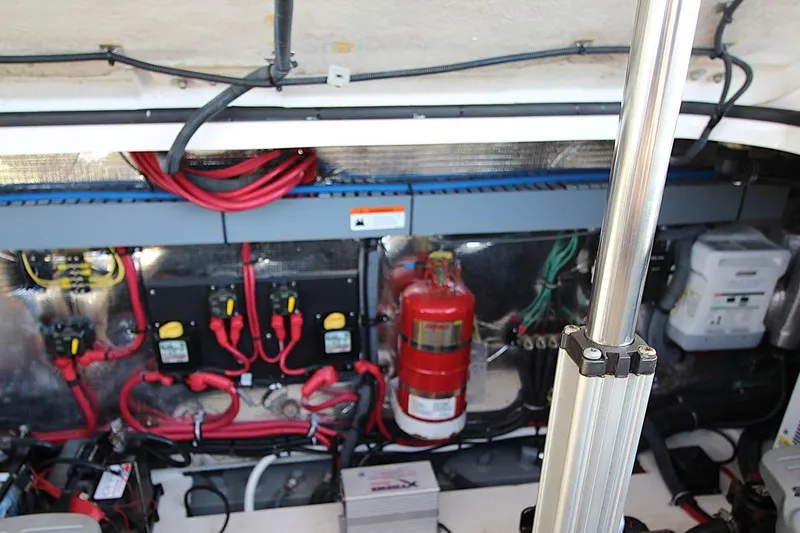 Slide: The Image of Engine compartment of a 2015 Regal 32 Express boat, featuring wiring and safety equipment. - 24