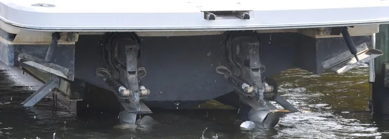 Slide: The Image of 2015 Regal 32 Express boat stern with dual outboard motors in water. - 25