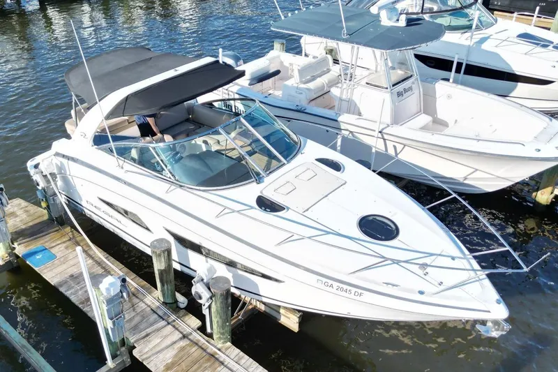 Slide: The Image of 2015 Regal 32 Express boat docked, featuring sleek design and spacious deck. - 7