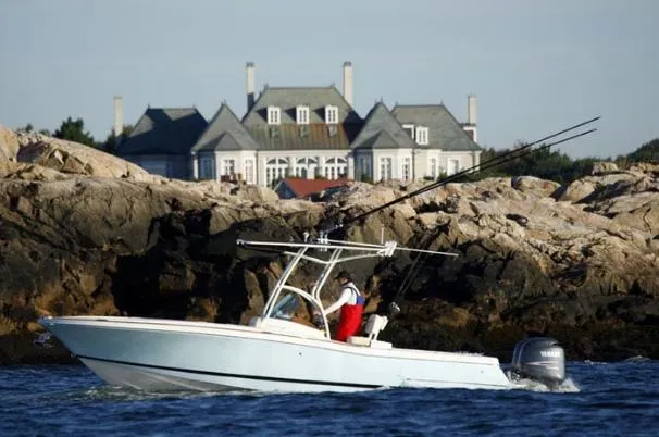 The Image of 2013 Chris-Craft Catalina 26 boat docked on a lift by the water. - 0