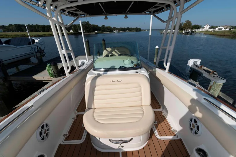 Slide: The Image of 2013 Chris-Craft Catalina 26 boat interior with beige seating and wooden deck. - 13