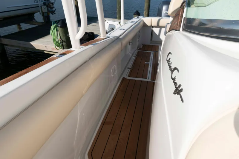 Slide: The Image of 2013 Chris-Craft Catalina 26 boat with teak deck and sleek white exterior. - 15
