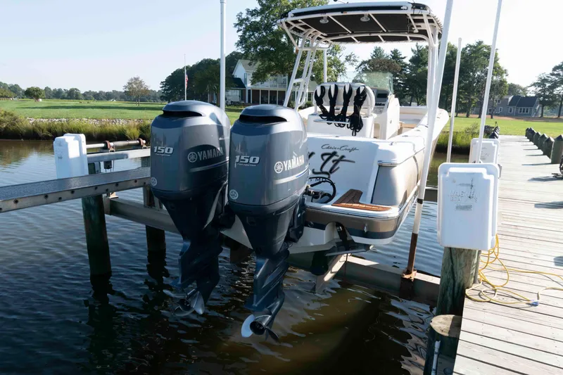 Slide: The Image of 2013 Chris-Craft Catalina 26 with twin Yamaha 150 engines docked by a pier. - 17