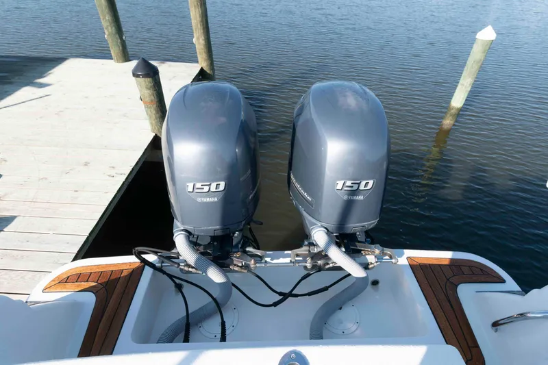 Slide: The Image of Twin Yamaha 150 engines on a 2013 Chris-Craft Catalina 26 at a dock. - 18