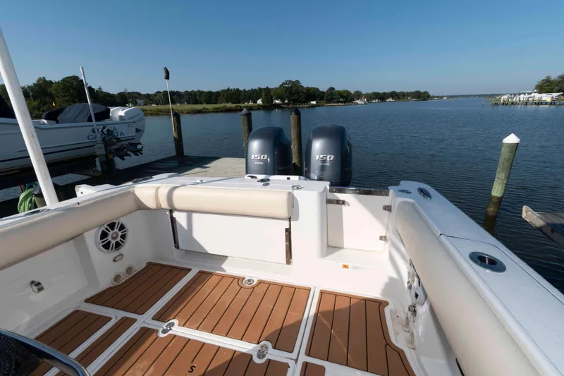 Slide: The Image of 2013 Chris-Craft Catalina 26 boat docked, featuring twin 150 engines and spacious deck. - 8