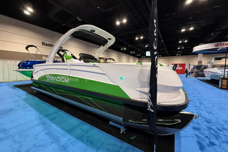 Slide: The Image of 2025 Paradigm 25SS boat displayed at an indoor exhibition, featuring sleek green and white design. - 3