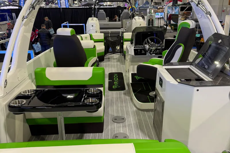 Slide: The Image of 2025 Paradigm 25SS boat interior with green and white seating, modern dashboard, and sleek design. - 4