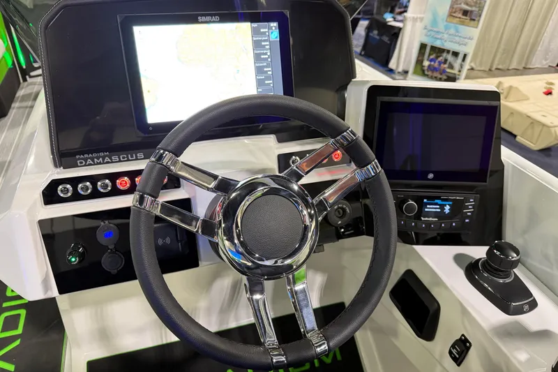 Slide: The Image of 2025 Paradigm 25SS boat dashboard with steering wheel and digital displays. - 5