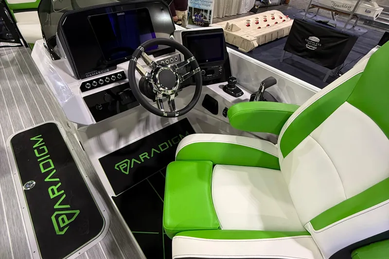 Slide: The Image of Cockpit of 2025 Paradigm 25SS boat with green and white seating, modern controls. - 9
