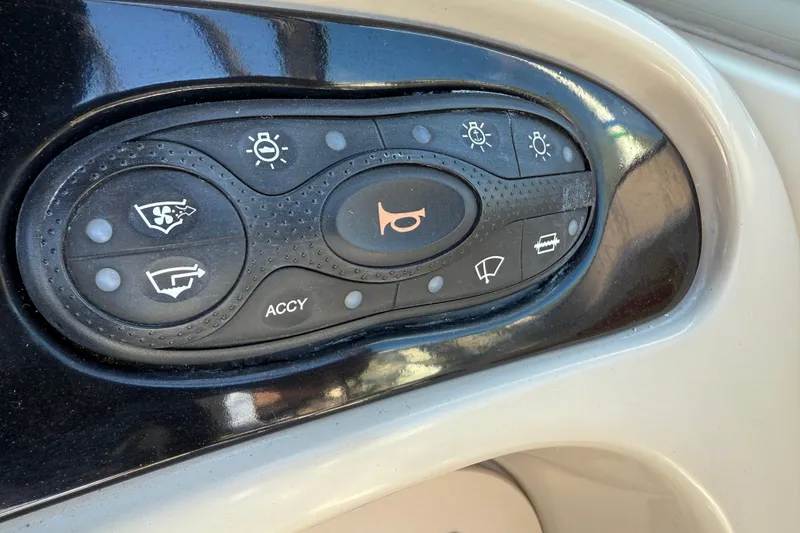 Slide: The Image of Control panel of a 2001 Sea Ray 260 Sundancer boat with various function buttons. - 13