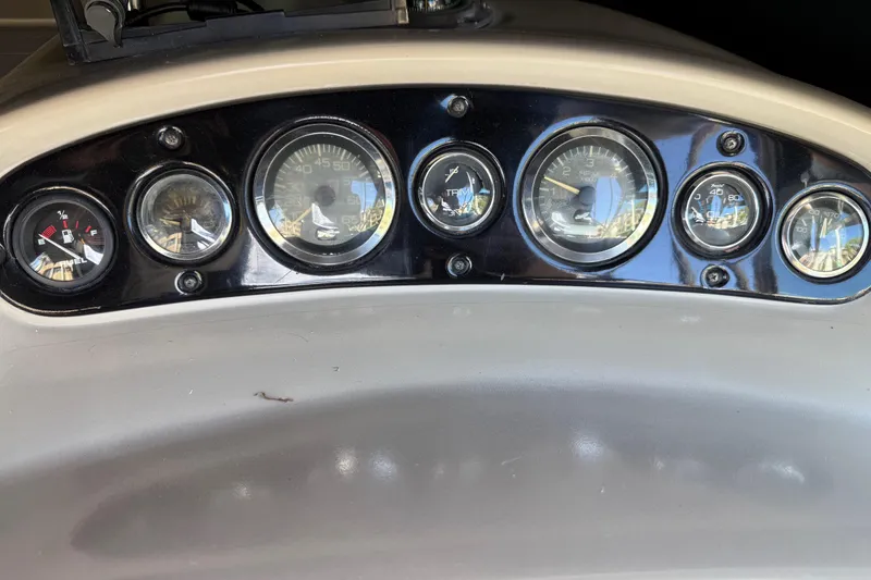 Slide: The Image of Dashboard of a 2001 Sea Ray 260 Sundancer boat with various gauges. - 15