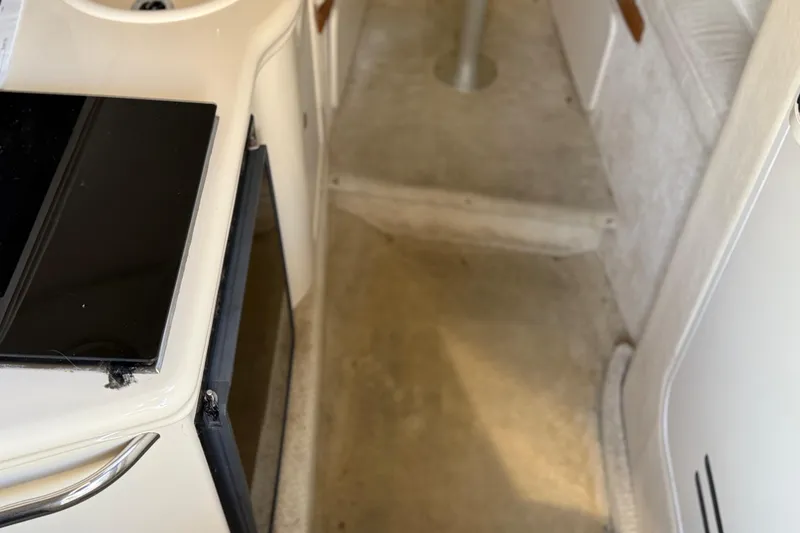 Slide: The Image of 2001 Sea Ray 260 Sundancer cabin interior with kitchenette and seating area. - 17