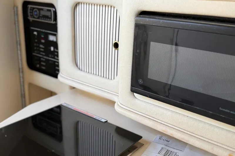 Slide: The Image of Interior of 2001 Sea Ray 260 Sundancer with microwave and control panel. - 18