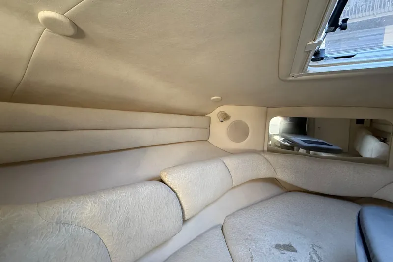 Slide: The Image of Interior cabin of 2001 Sea Ray 260 Sundancer with beige upholstery and window. - 26