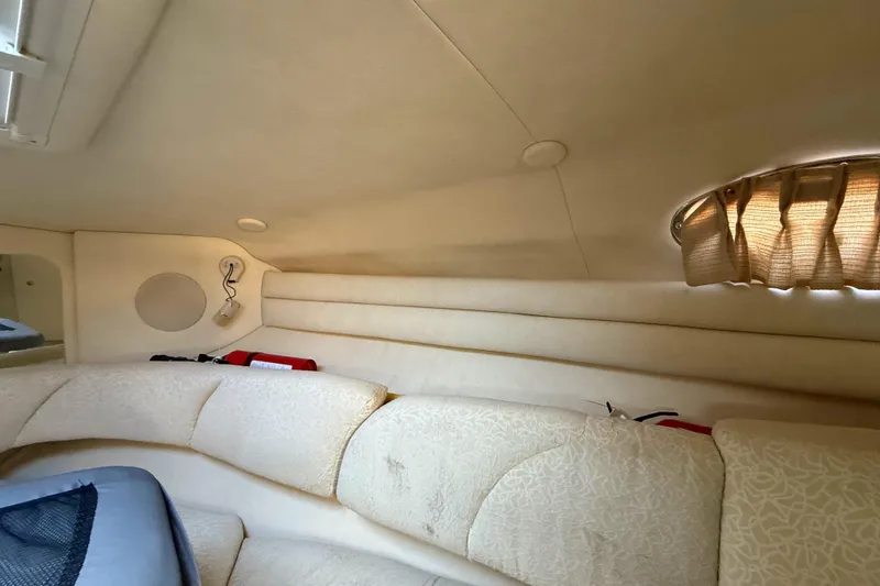Slide: The Image of Interior cabin of 2001 Sea Ray 260 Sundancer with beige upholstery and porthole window. - 27