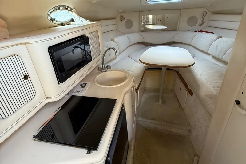 Slide: The Image of Interior of 2001 Sea Ray 260 Sundancer with kitchenette and seating area. - 31