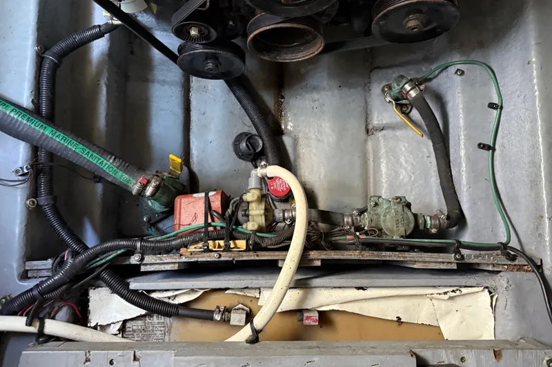 Slide: The Image of Engine compartment of a 2001 Sea Ray 260 Sundancer with visible hoses and components. - 36