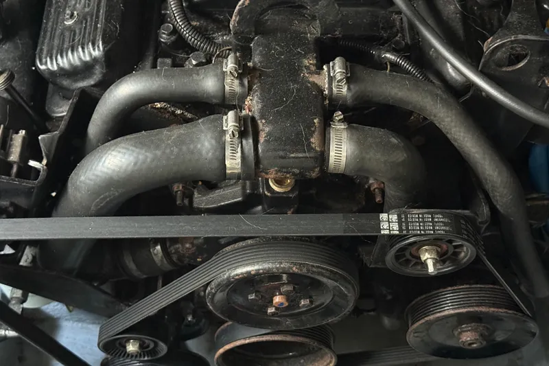 Slide: The Image of Engine components of a 2001 Sea Ray 260 Sundancer boat, featuring belts and hoses. - 39