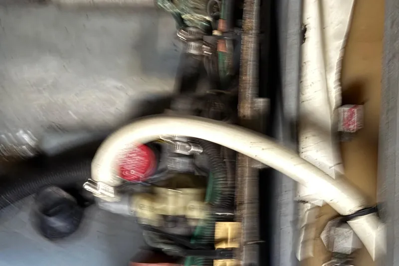Slide: The Image of Engine compartment of a 2001 Sea Ray 260 Sundancer boat, showing hoses and components. - 40