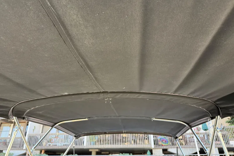 Slide: The Image of Bimini top of a 2001 Sea Ray 260 Sundancer boat, showcasing sturdy frame and fabric. - 5