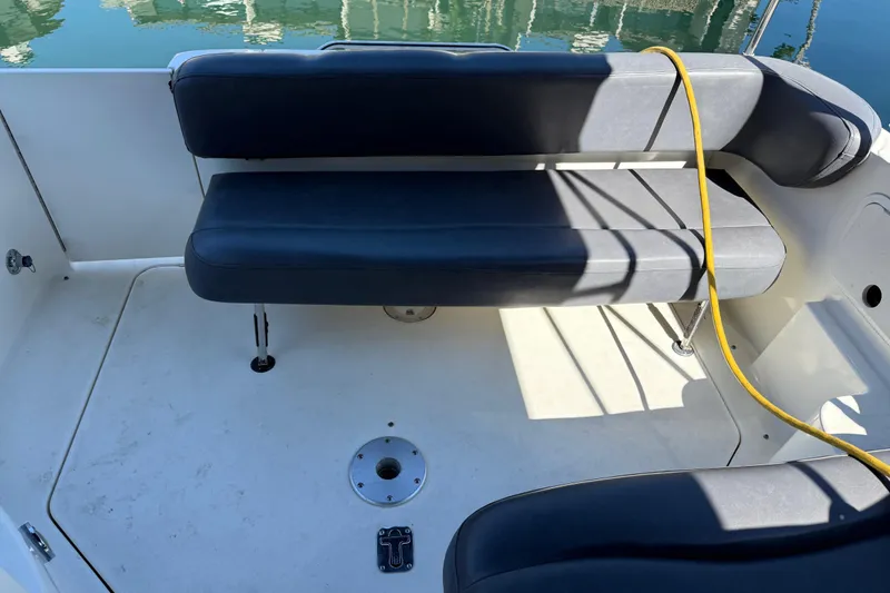 Slide: The Image of 2001 Sea Ray 260 Sundancer boat interior with black seating and yellow cable. - 6