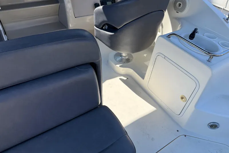 Slide: The Image of 2001 Sea Ray 260 Sundancer interior with blue seating and white console. - 7