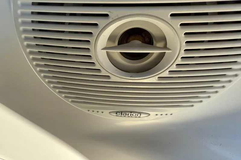 Slide: The Image of Clarion speaker on 2001 Sea Ray 260 Sundancer boat, featuring a circular grille design. - 9