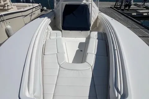 Slide: The Image of 2017 Regulator 31 boat with white seating and sleek design at a dock. - 11